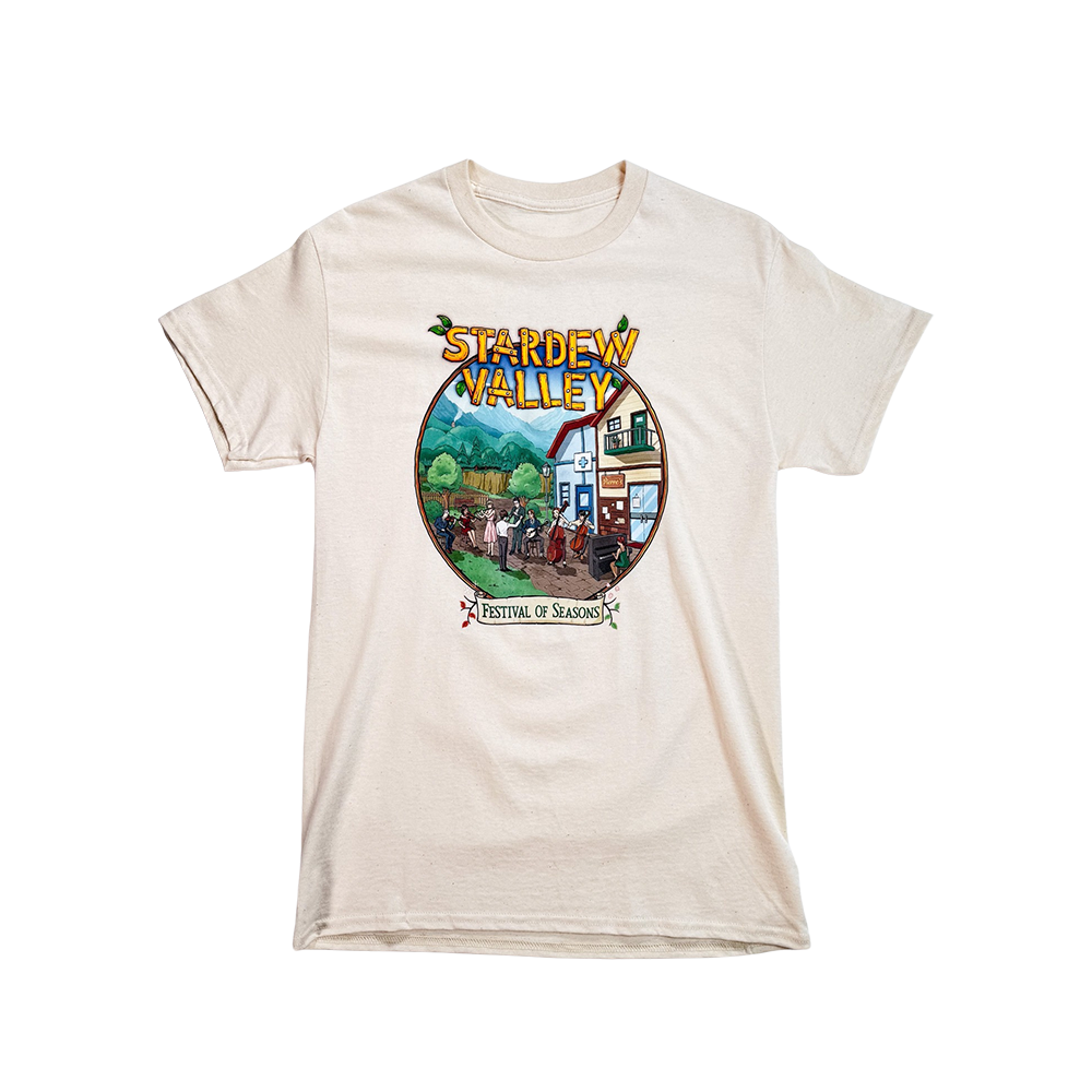 White t-shirt featuring a colorful ’Stardew Valley’ game design with a rural scene.