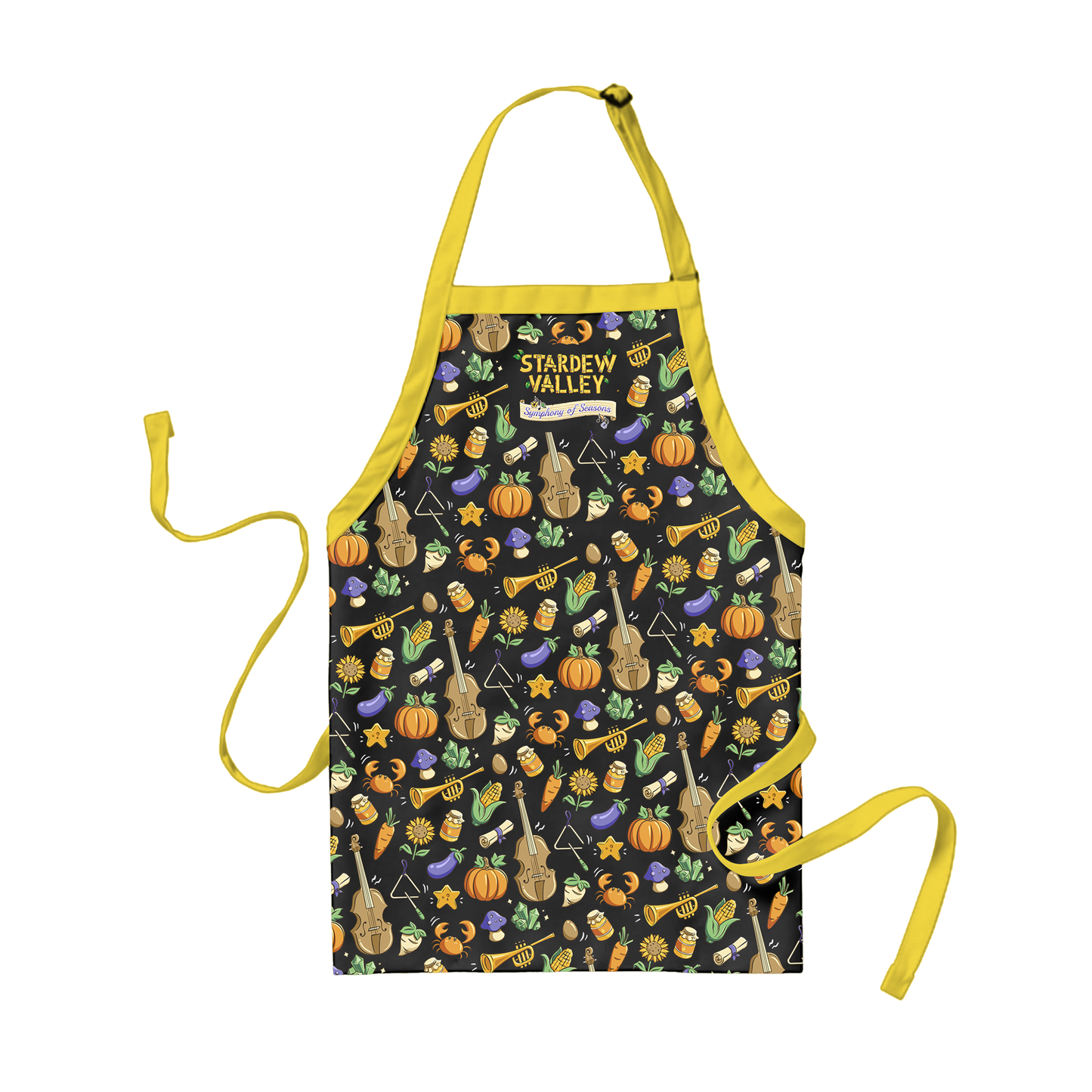 A black apron with yellow straps and ties, featuring a playful pattern of violins, trumpets, pumpkins, carrots, mushrooms, and stars in warm tones.