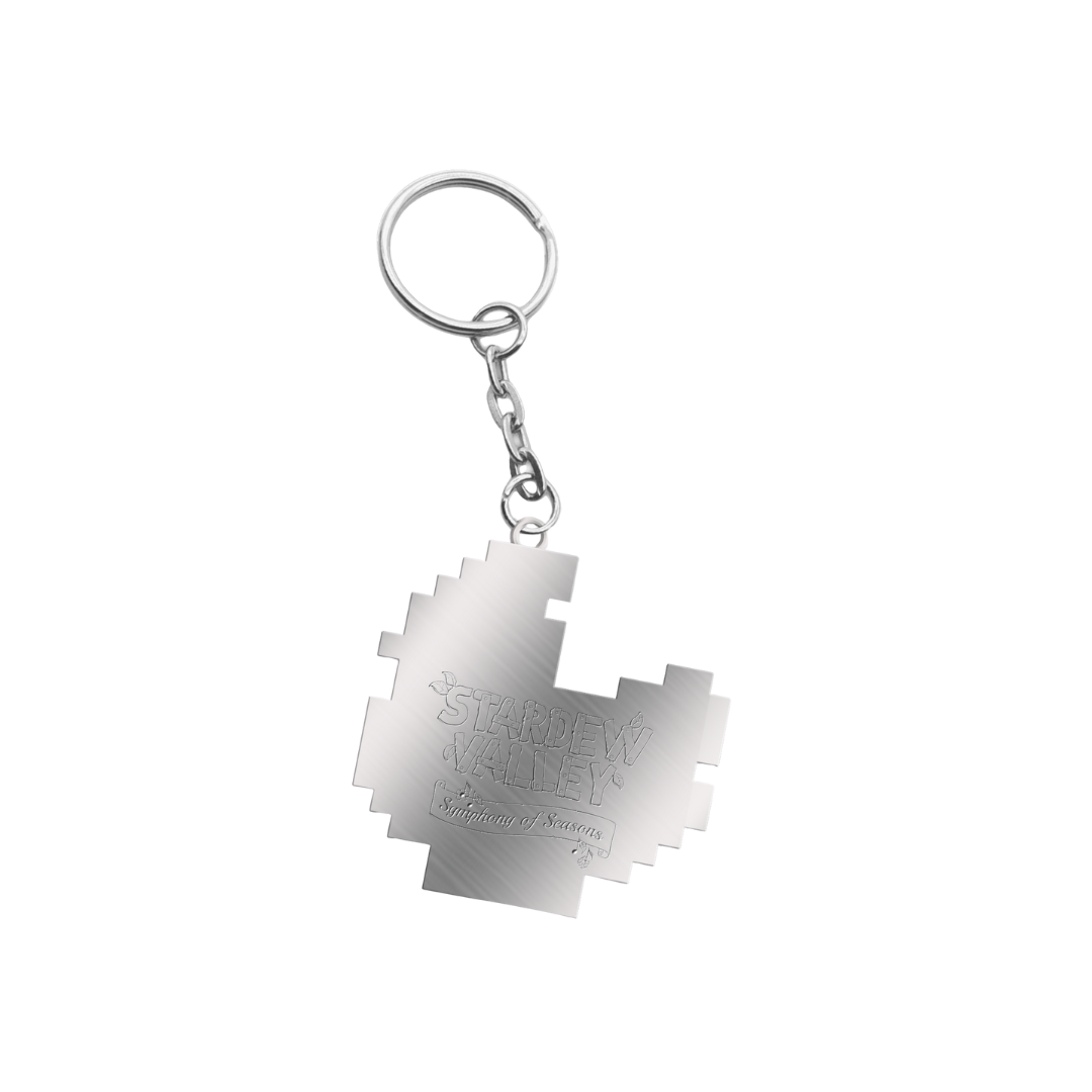 Silver metallic keychain shaped like a pixelated map of stardew valley, featuring engraved text.
