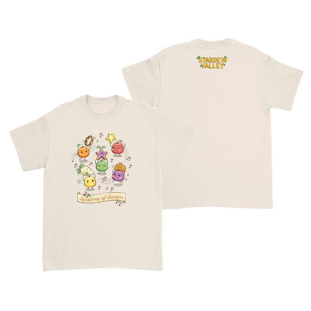 Cream-colored starbound t-shirt featuring a colorful, cartoonish design of animated fruits and vegetables from the game.