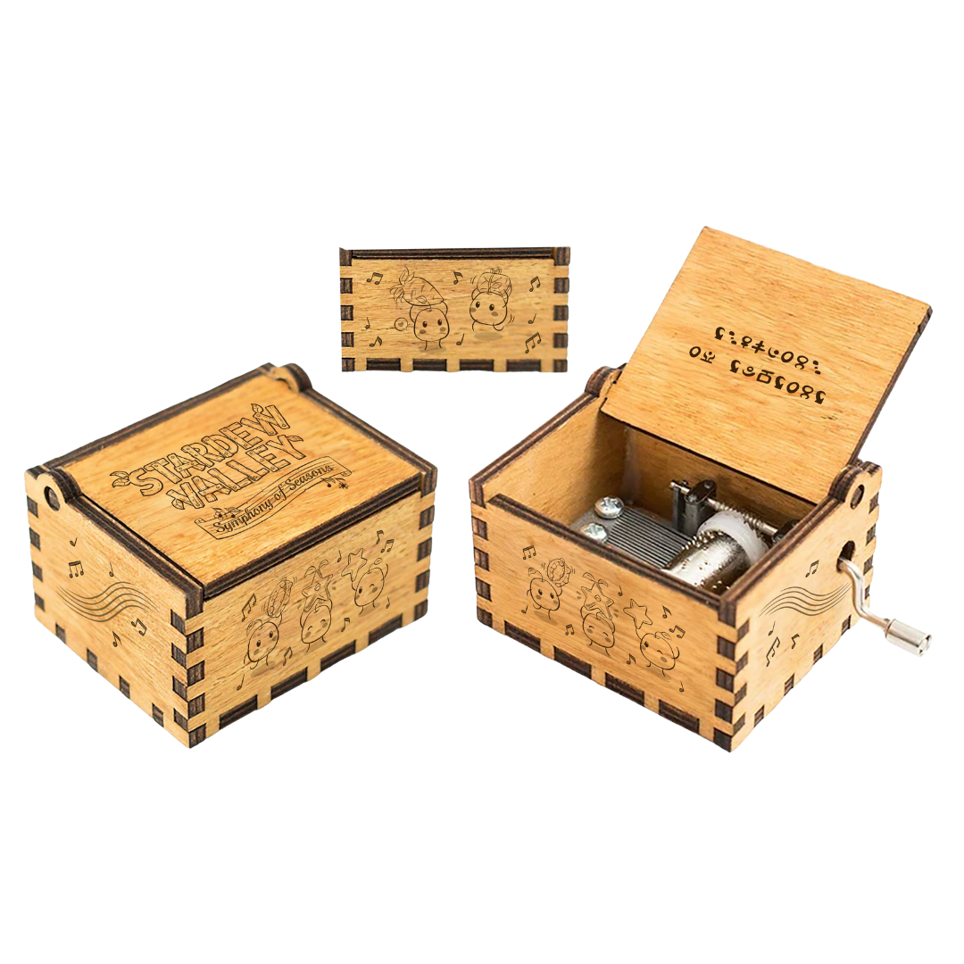 A light brown wooden music box with engraved cartoon characters and musical notes, featuring a visible internal mechanism and crank handle.