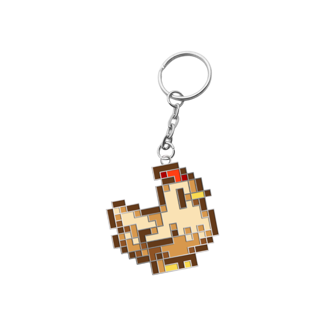 Pixelated chicken keychain with a silver metal ring and chain, featuring brown and beige tones with red and yellow accents.